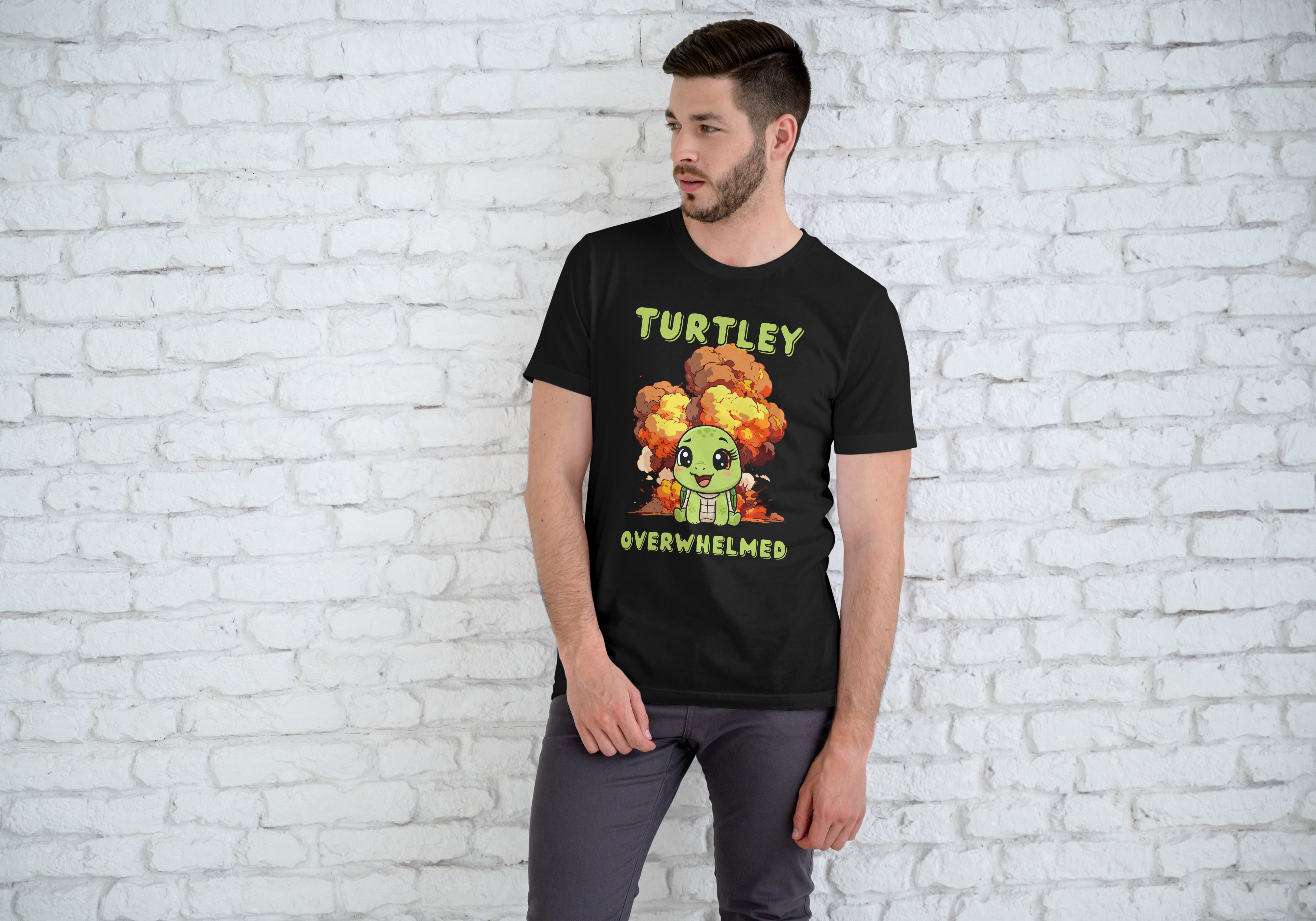Man wearing a black t-shirt with a graphic design and text, standing against a white brick wall.